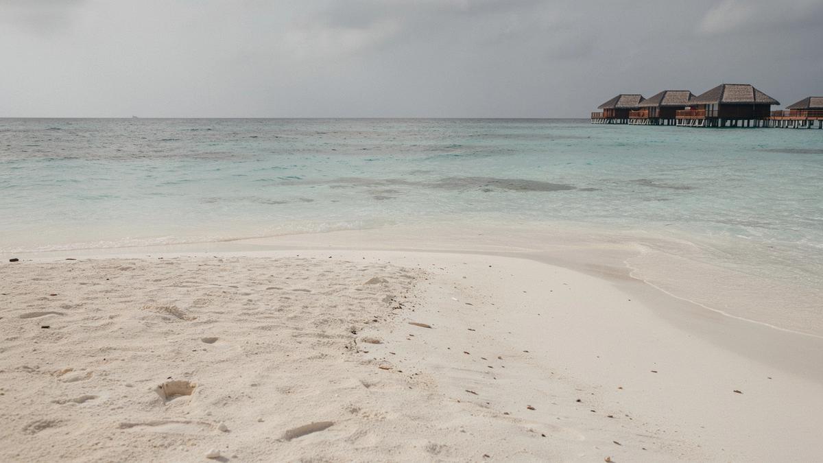 Turquoise lagoon and pale sandbank beside a Maldives resort atoll